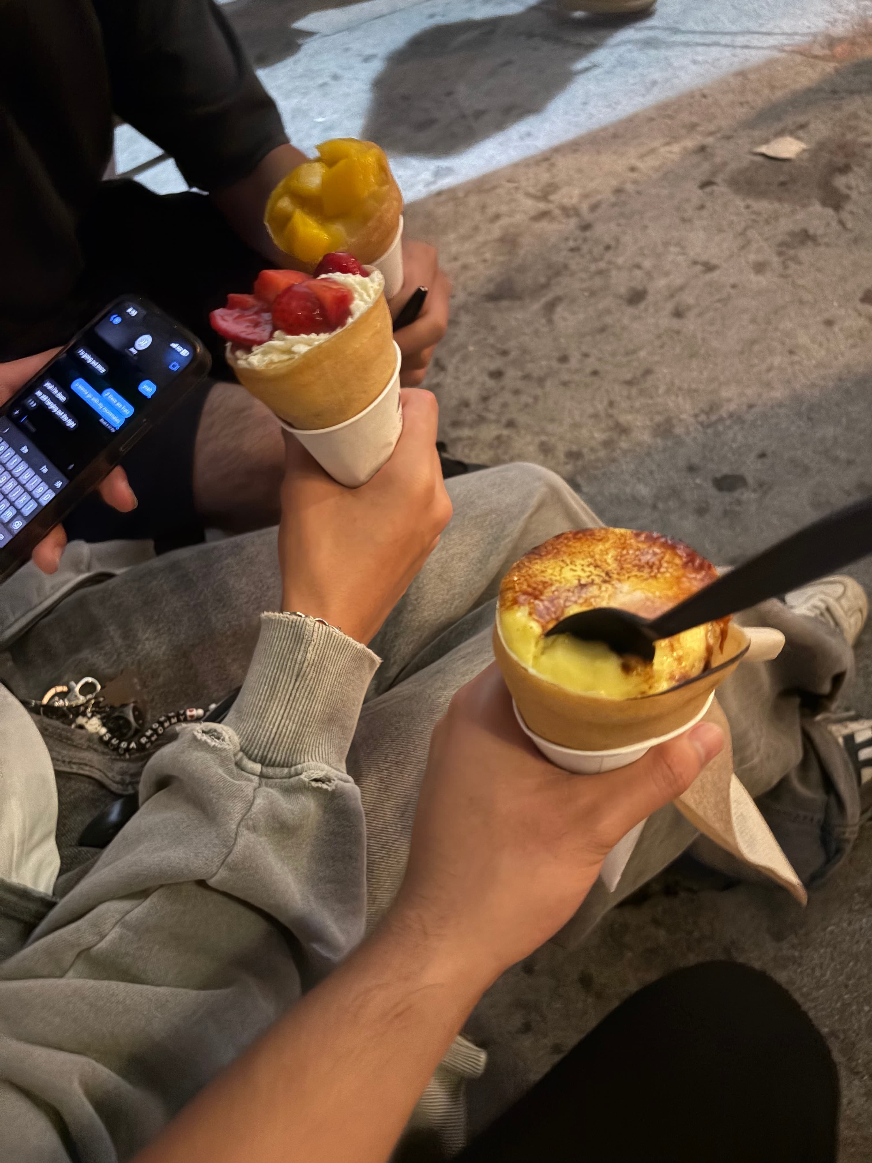 Three dessert crepes with mango, strawberry, and creme brulee toppings