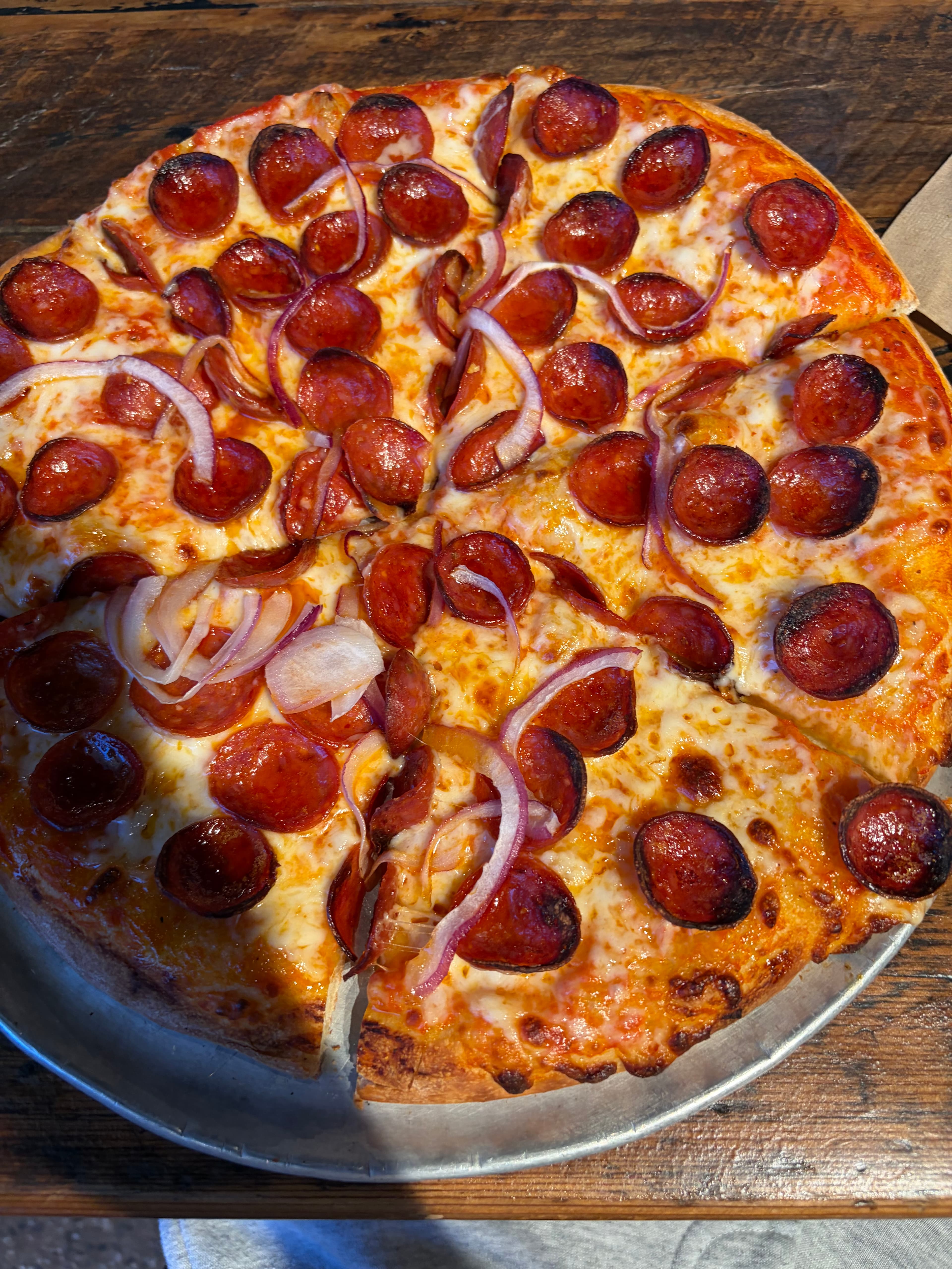 Pepperoni pizza with red onion