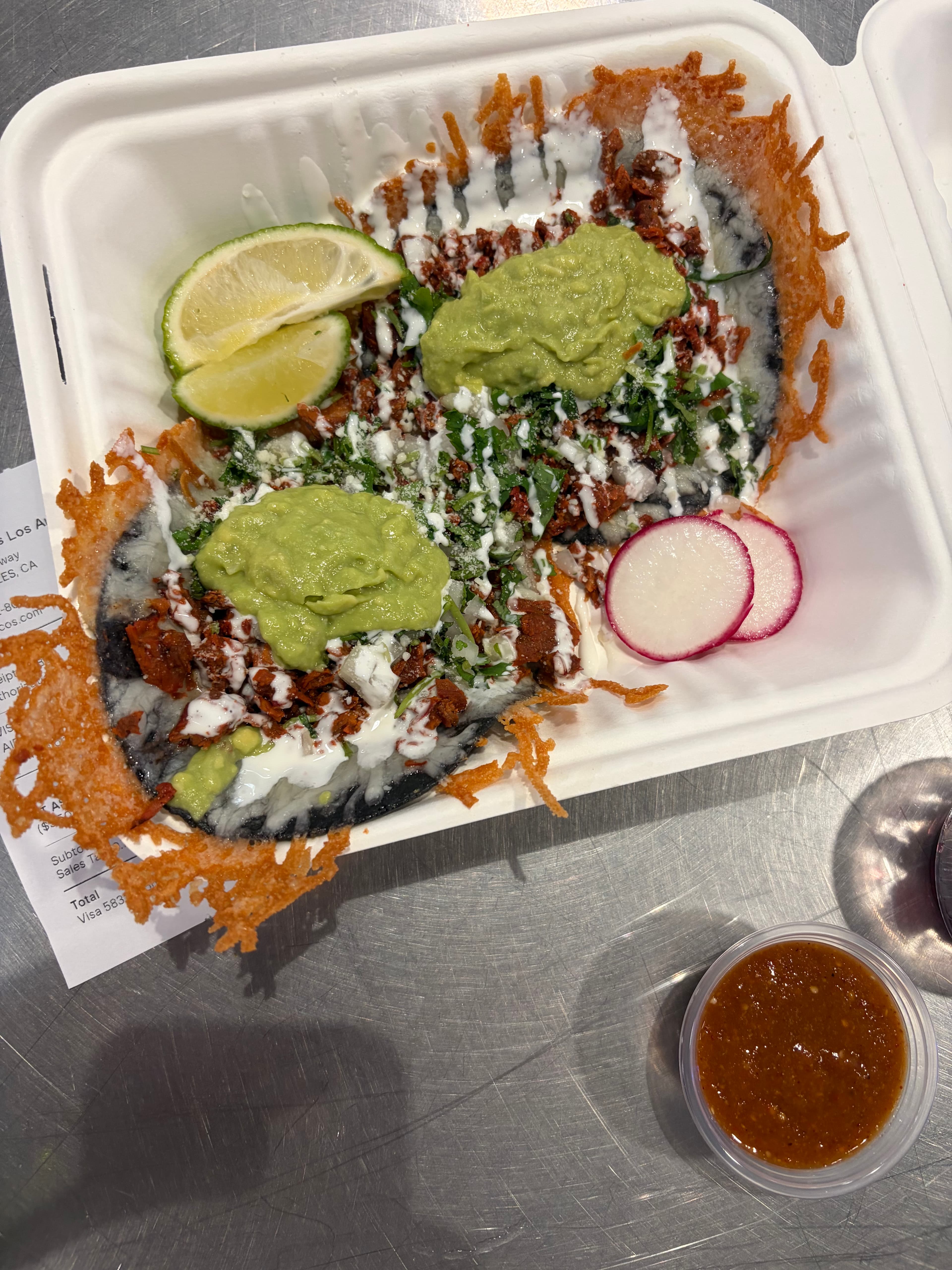 Crispy cheese tacos with guacamole, lime, and salsa