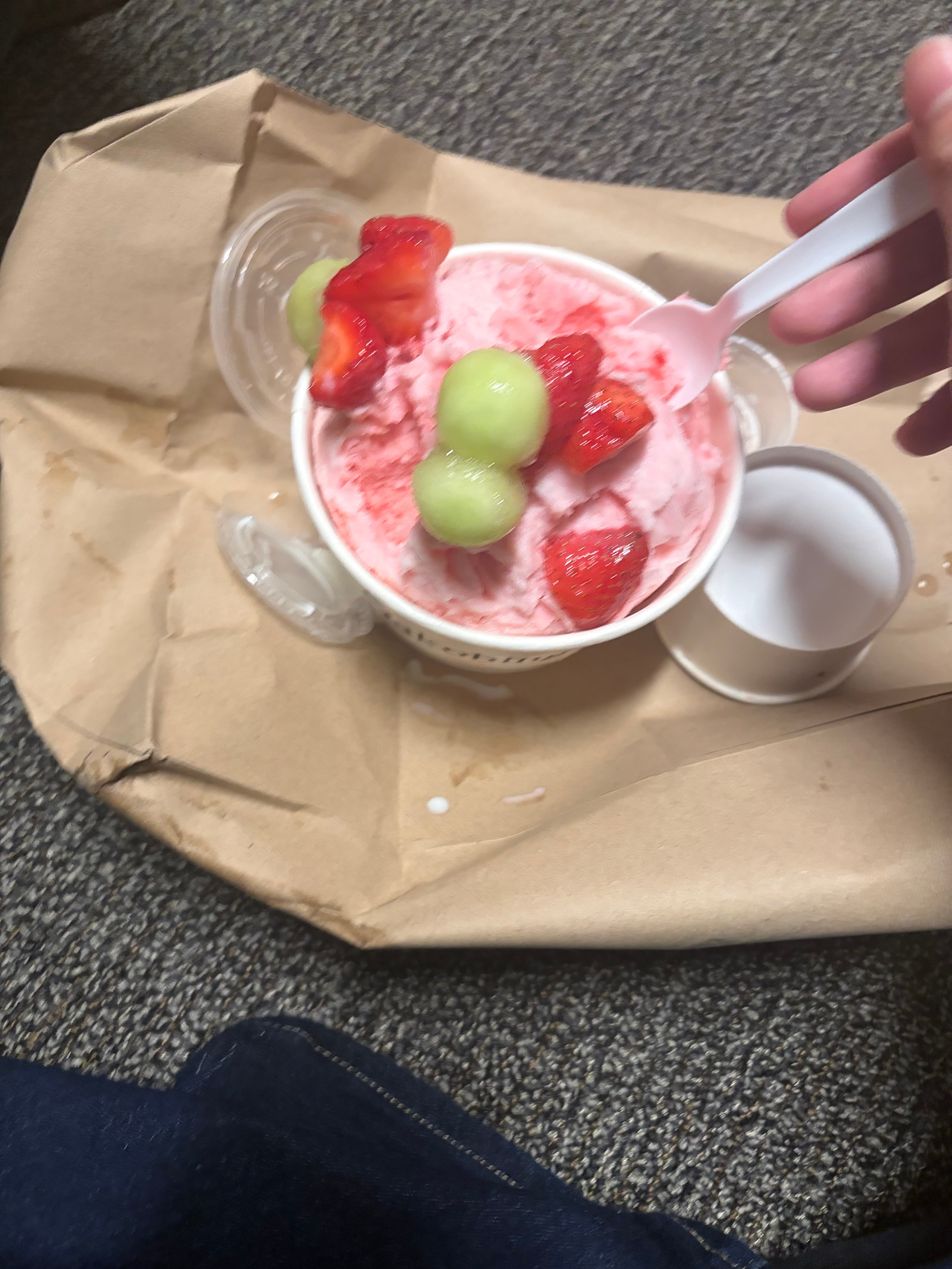 Pink shaved ice with strawberries and melon balls