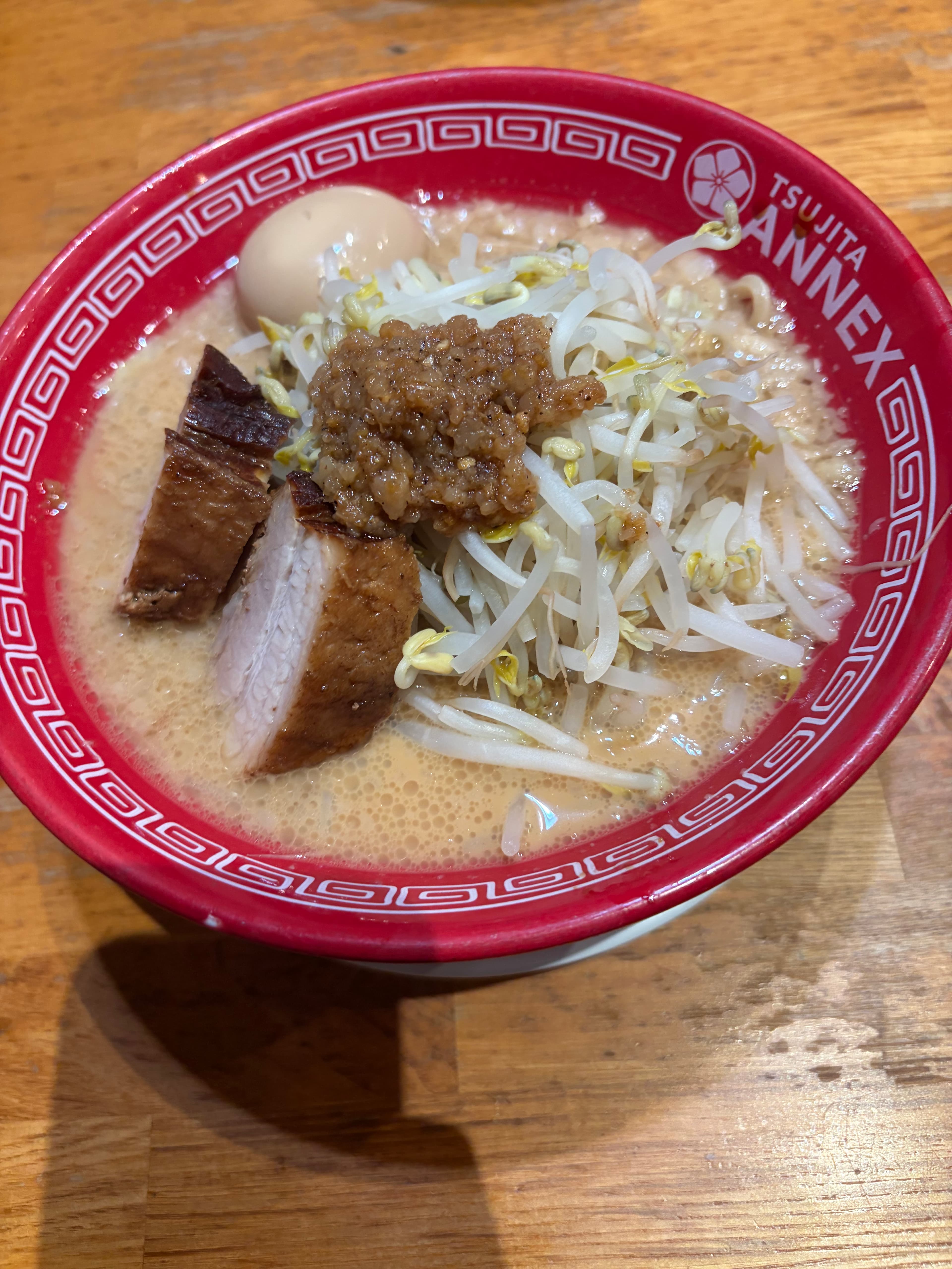 Ramen in a red Tsujita Annex bowl