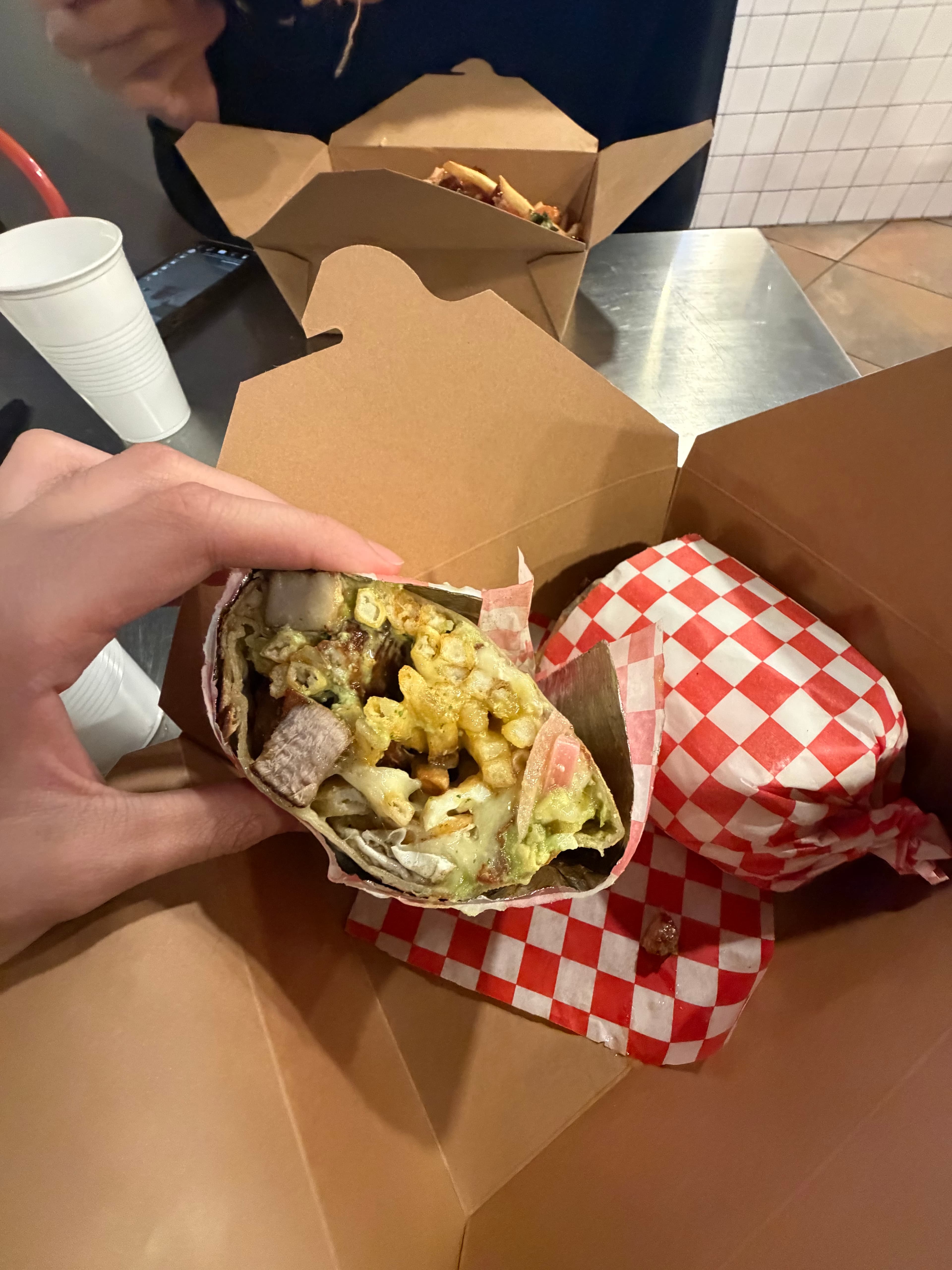 Cut open wrap with avocado and vegetables