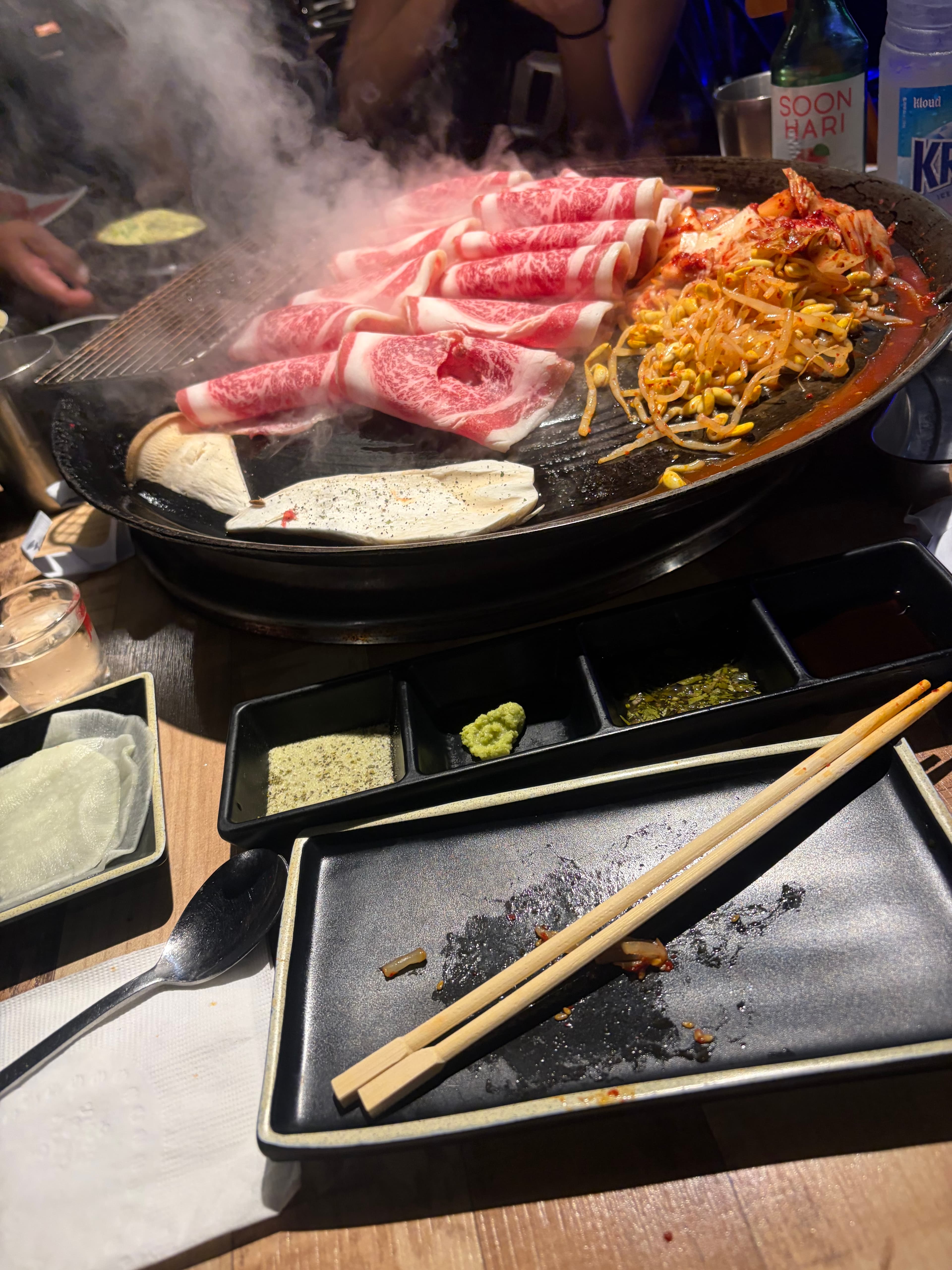 Korean barbecue grill with sliced beef and spicy vegetables