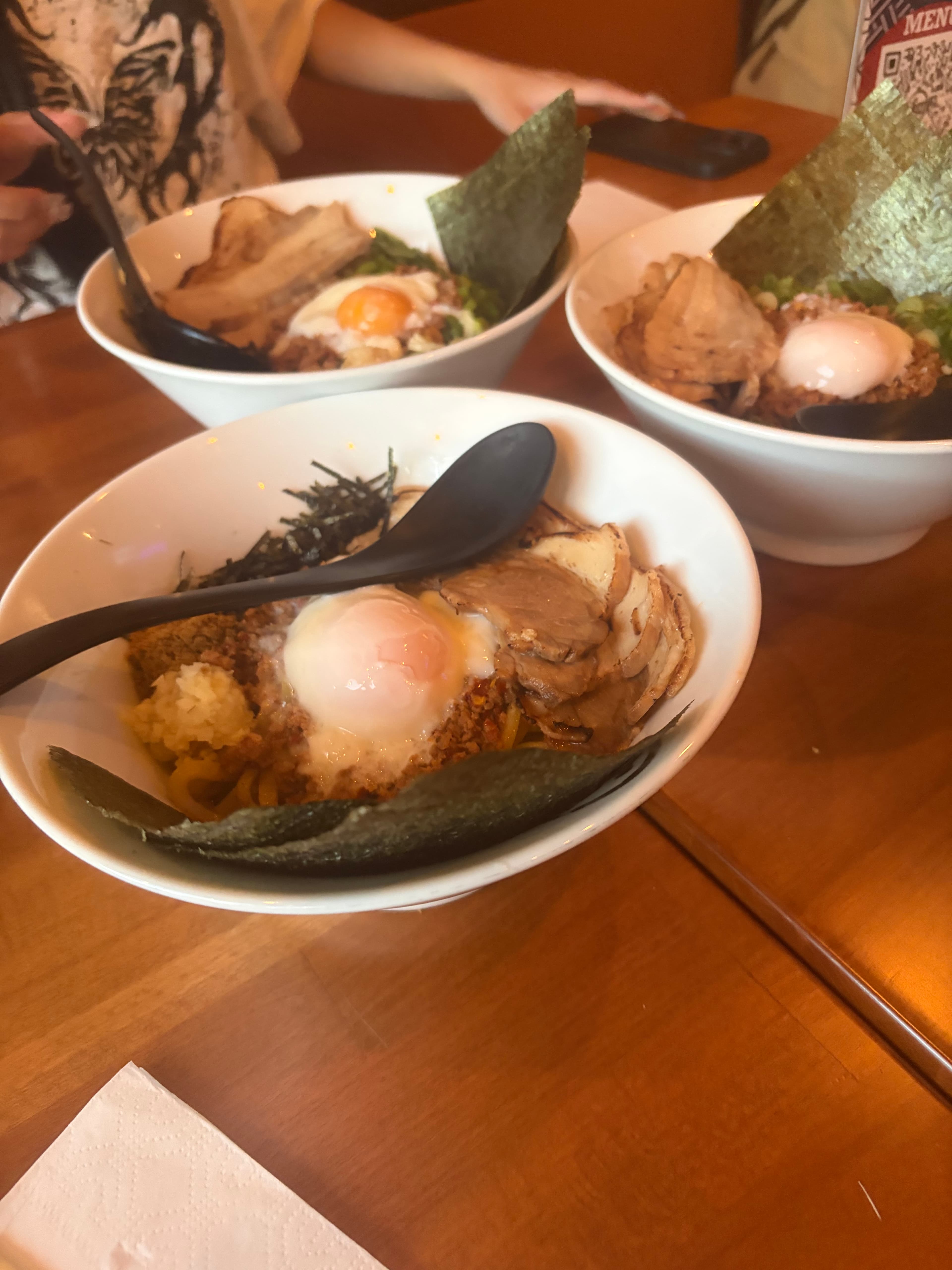 Three bowls of dry ramen with eggs and seaweed