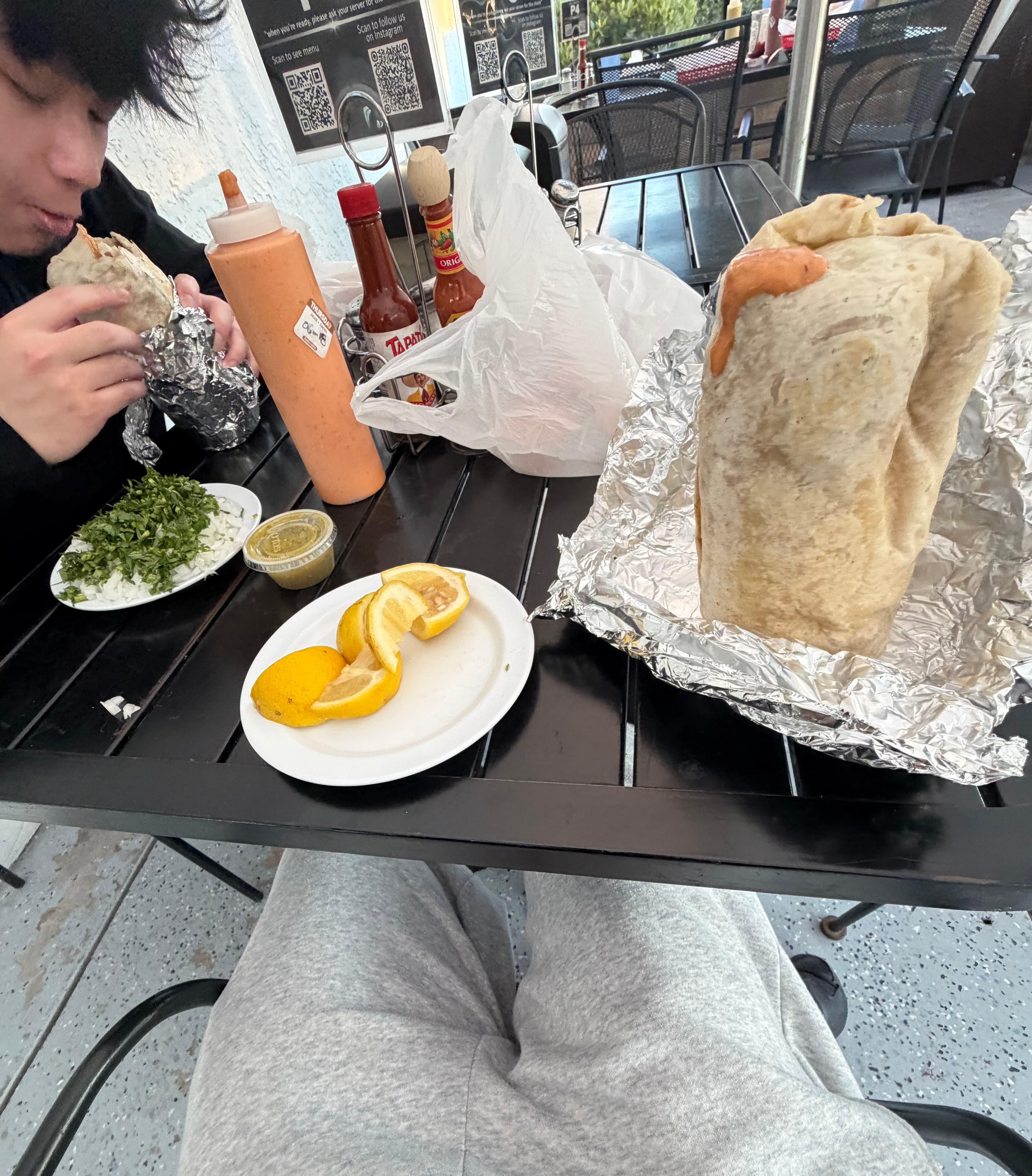 Tacos and sauces on an outdoor table